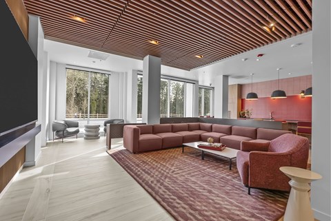 A living room with a red carpet and a wooden ceiling.
