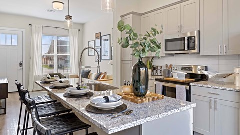 A modern kitchen with a dining table set for four.