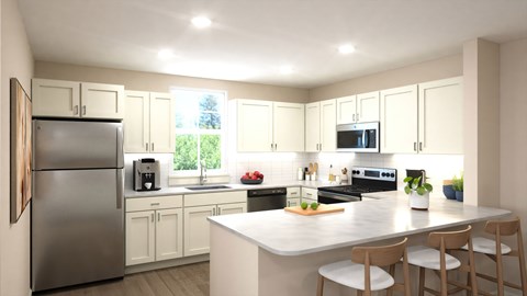 A modern kitchen with a refrigerator, microwave, and oven.