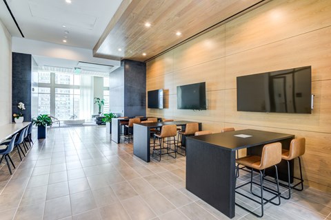 A modern dining room with a long table and chairs.