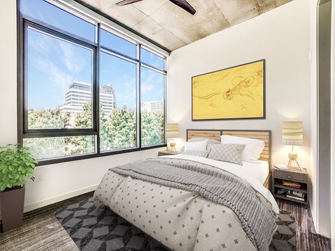 A bedroom with a large bed and a view of the city.