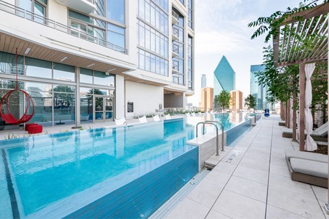 A long rectangular pool is surrounded by a white tiled floor.