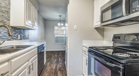 A kitchen with a black stove top oven.