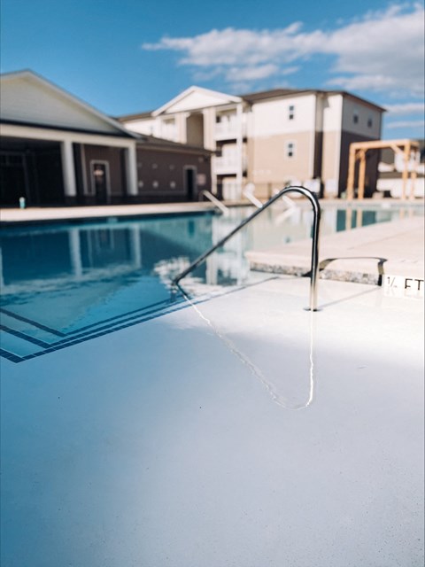 A pool with a white ladder in the middle of it.