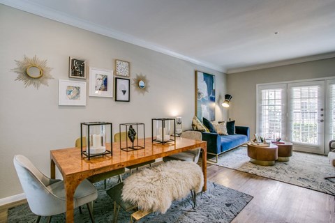 A dining room with a wooden table and chairs.