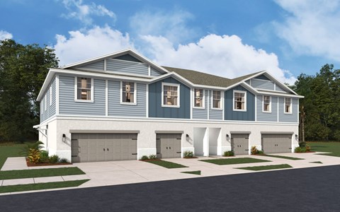 A modern house with a grey and white exterior and a large driveway.