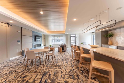 A modern dining area with a long table and chairs.