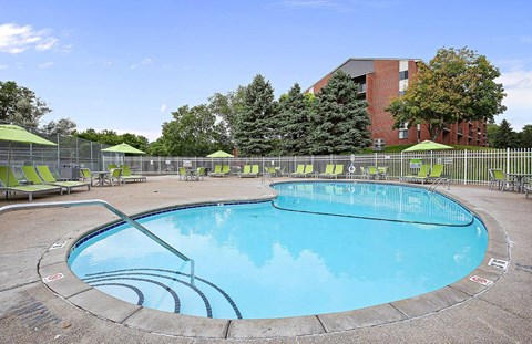 A round swimming pool with a metal fence around it.