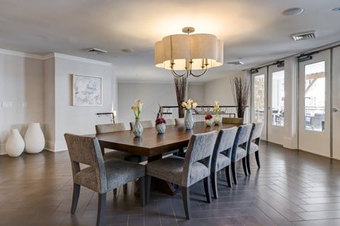 A dining room with a table set for six.