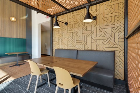 A dining area with a wooden table and chairs.