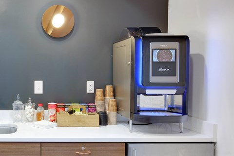 A modern kitchen with a NeoTera oven on the counter.