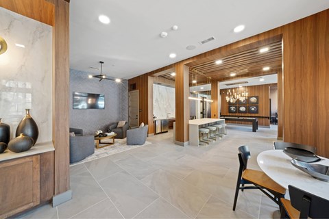 A modern kitchen with a dining table and chairs.