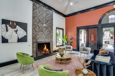A living room with a fireplace and a painting on the wall.