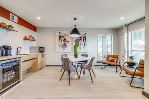 A modern kitchen with a dining table set for four.
