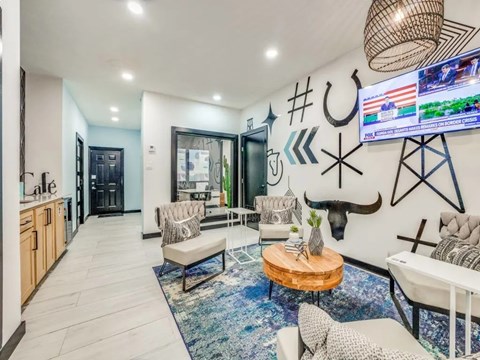 A modern living room with a flat screen TV mounted on the wall.