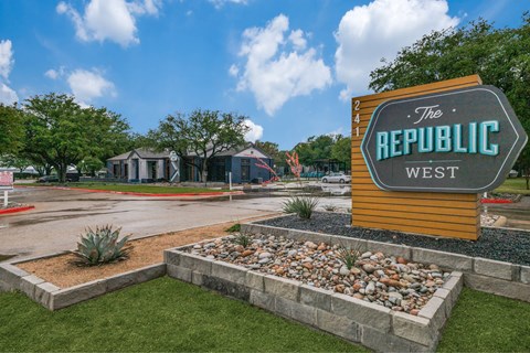 A sign that says "The Republic West" is in front of a building.