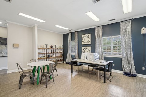 A dining room with a white table and chairs.