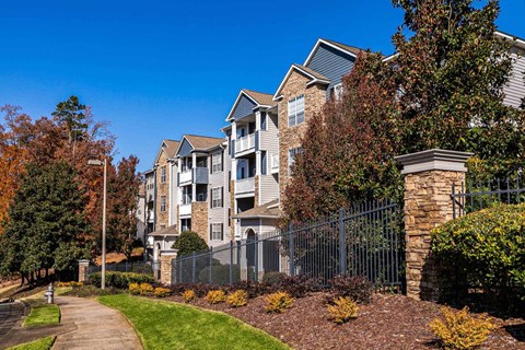 A residential area with apartment buildings and a sidewalk.