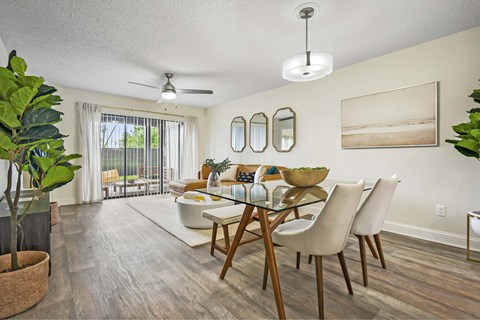 A dining room with a glass table and chairs.