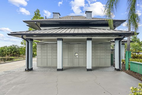 A modern house with a grey roof and pillars.