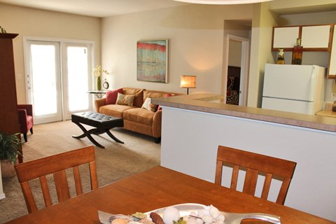 A dining room with a wooden table and chairs.