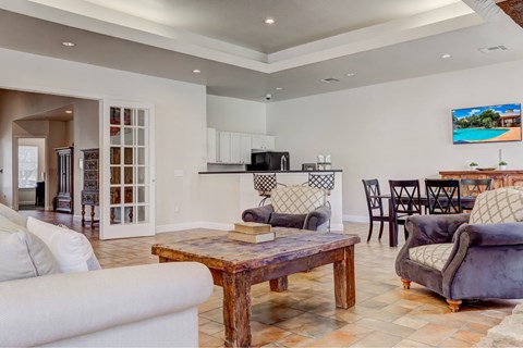 A modern living room with a large white couch and a wooden coffee table.