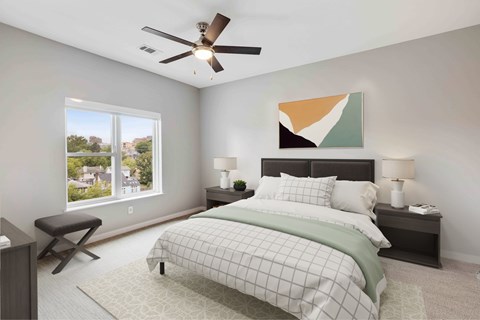 A bedroom with a large bed and a ceiling fan.