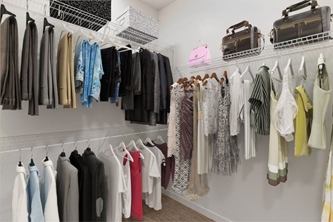 A closet full of clothes hanging on a rack.