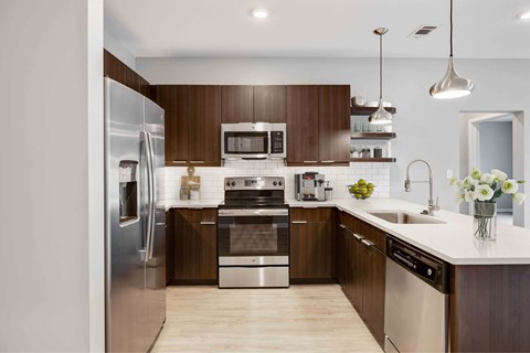 A modern kitchen with wooden cabinets and stainless steel appliances.