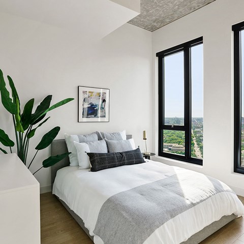Penthouse a bedroom with a bed and a large window