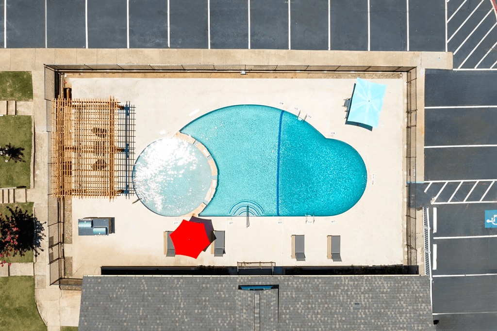 a birdseye view of a building with a blue roof and a red and white umbrella