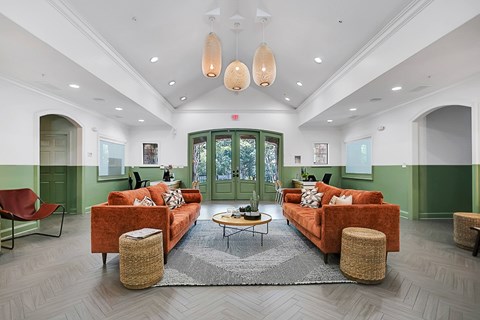 a living room with couches and chairs and a rug