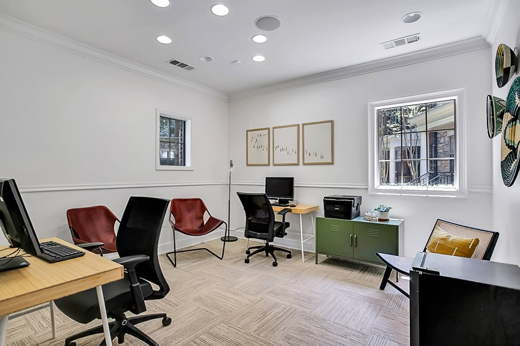 an office with desks and chairs and a computer