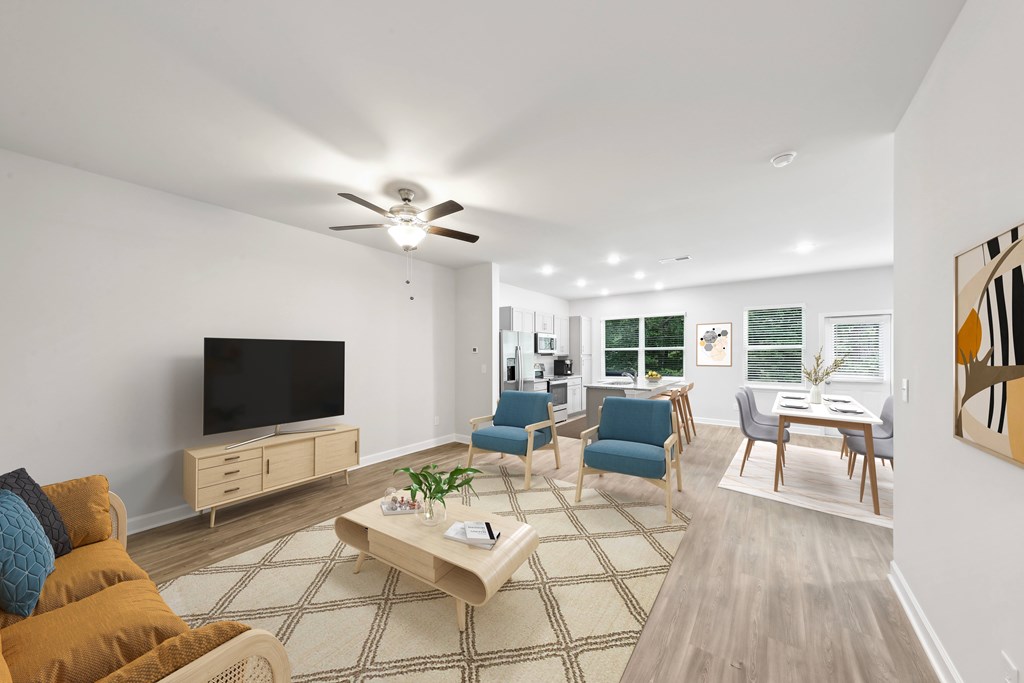 a living room with a ceiling fan and a tv