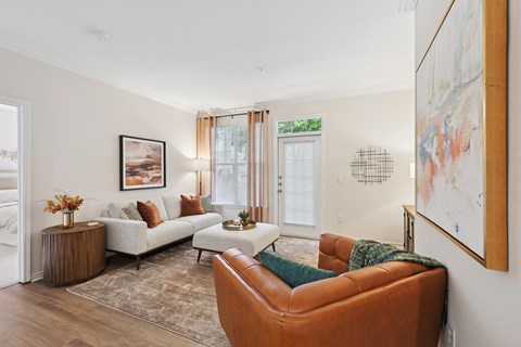 A living room with a brown leather chair and a white sofa.