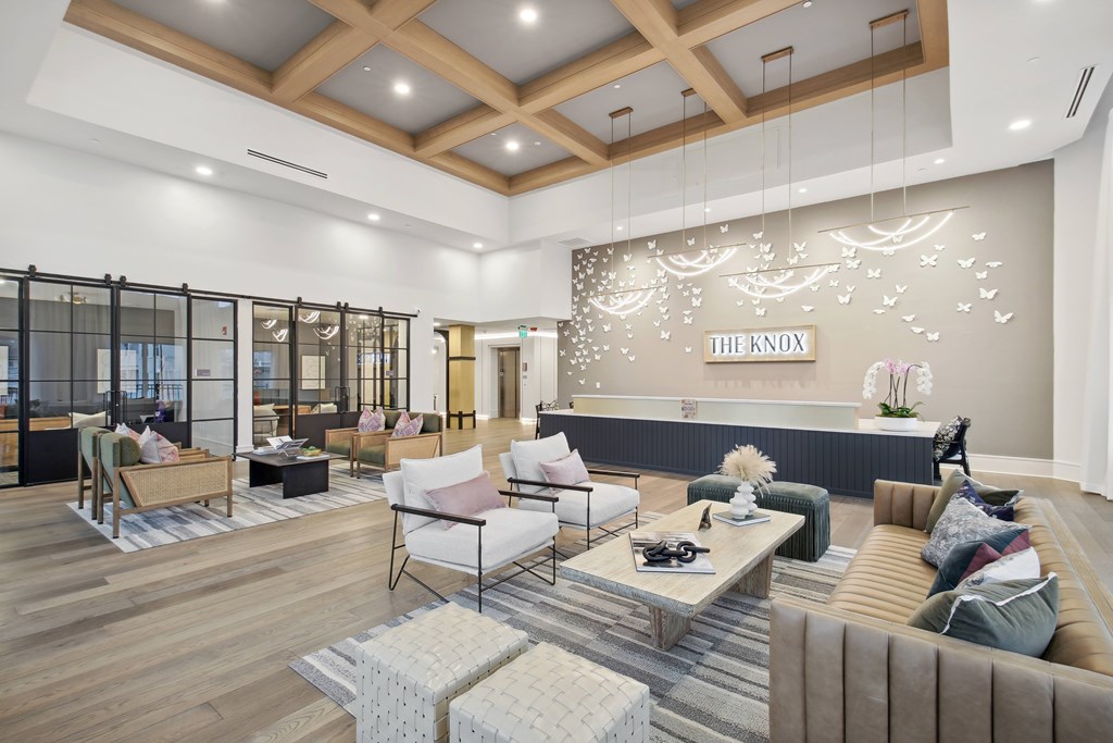 a lobby with couches and chairs and a reception desk