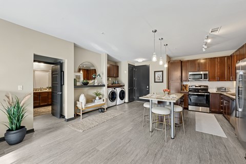 A modern kitchen with a dining table and chairs.