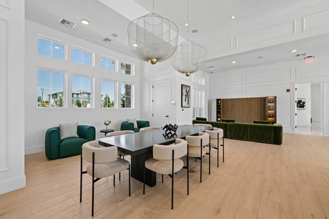 A dining room with a long table and chairs.