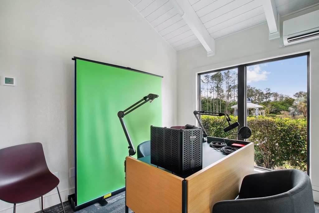 a room with a desk with a green door and a window