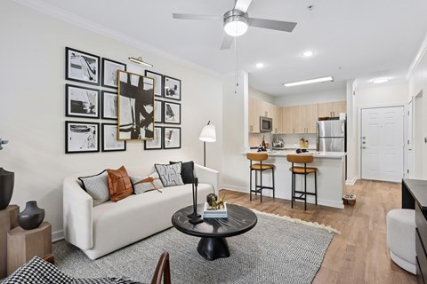 A living room with a white couch and a black coffee table.