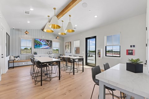 A modern dining room with a large table and chairs.