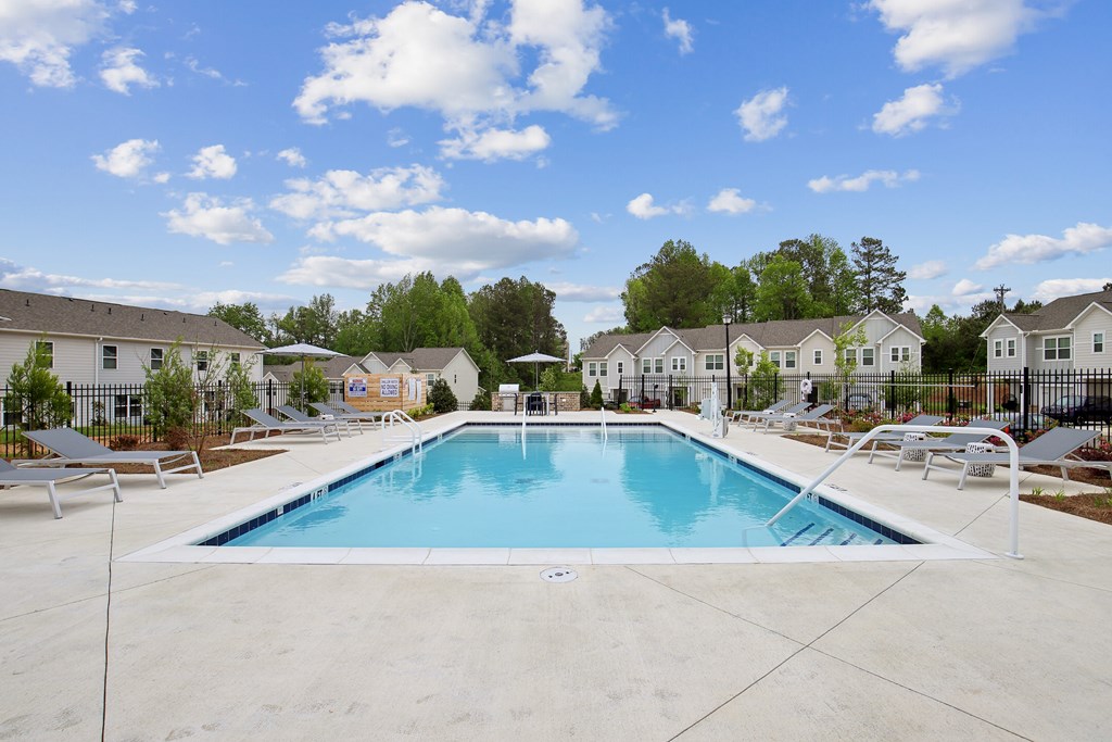 our apartments have a resort style pool with chairs and tables