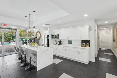 a large kitchen with white cabinets and a white counter top