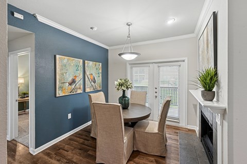 A dining room with a table and chairs.