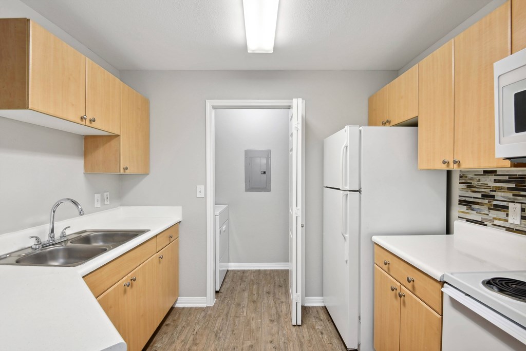 kitchen with white appliances and washer/dryer