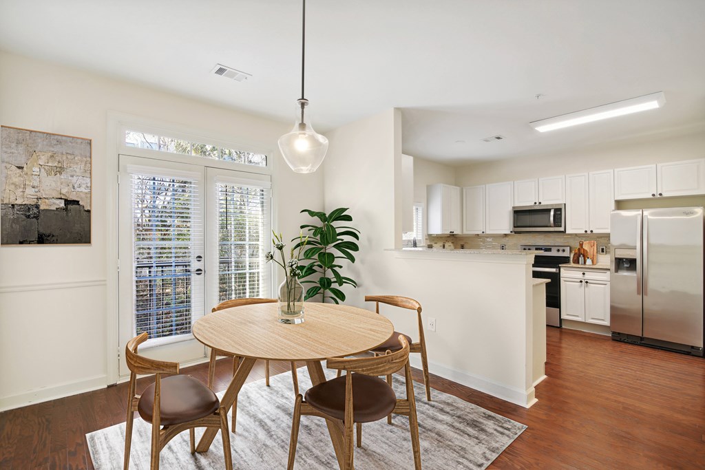 an open kitchen and dining room with a table and chairs