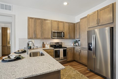 A kitchen with wooden cabinets and stainless steel appliances.