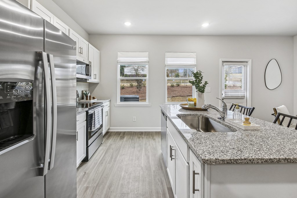 a kitchen with stainless steel appliances and granite counter tops