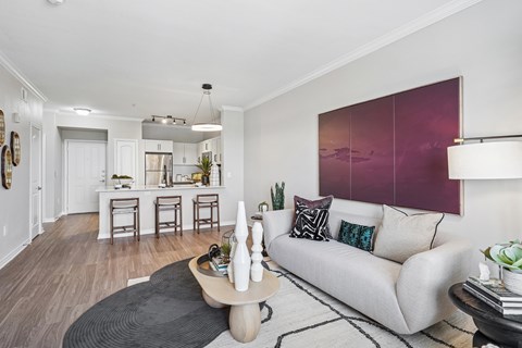 A living room with a white couch and a coffee table.