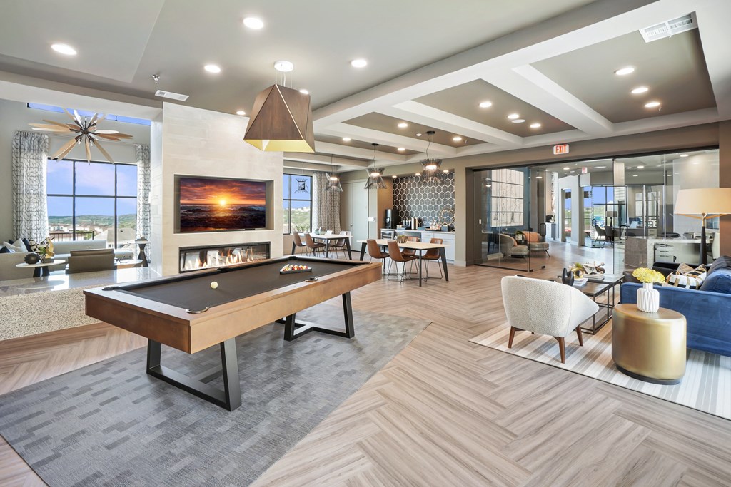 a large living room with a pool table and a fireplace